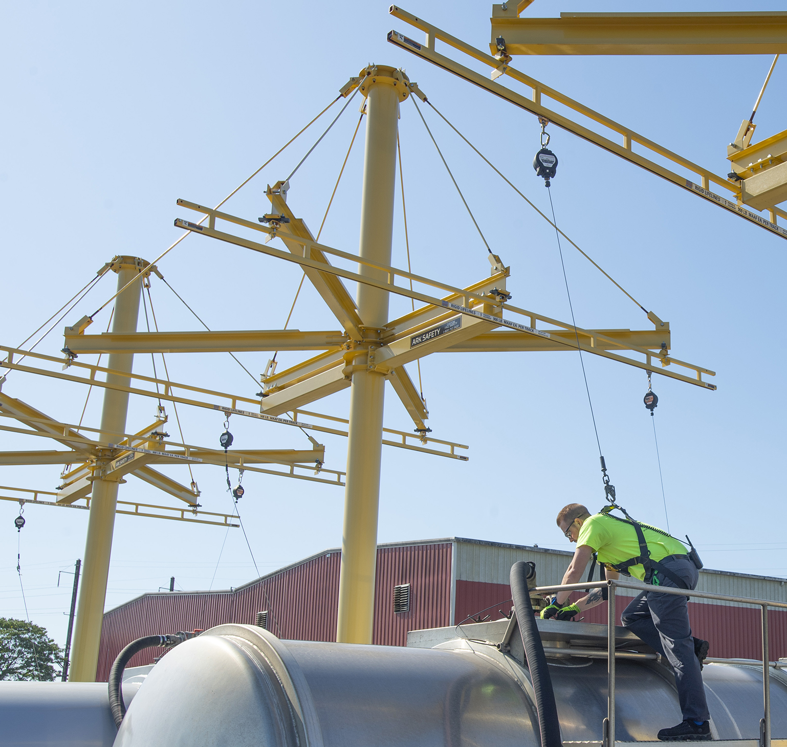 man attached to anchor tracks on post working